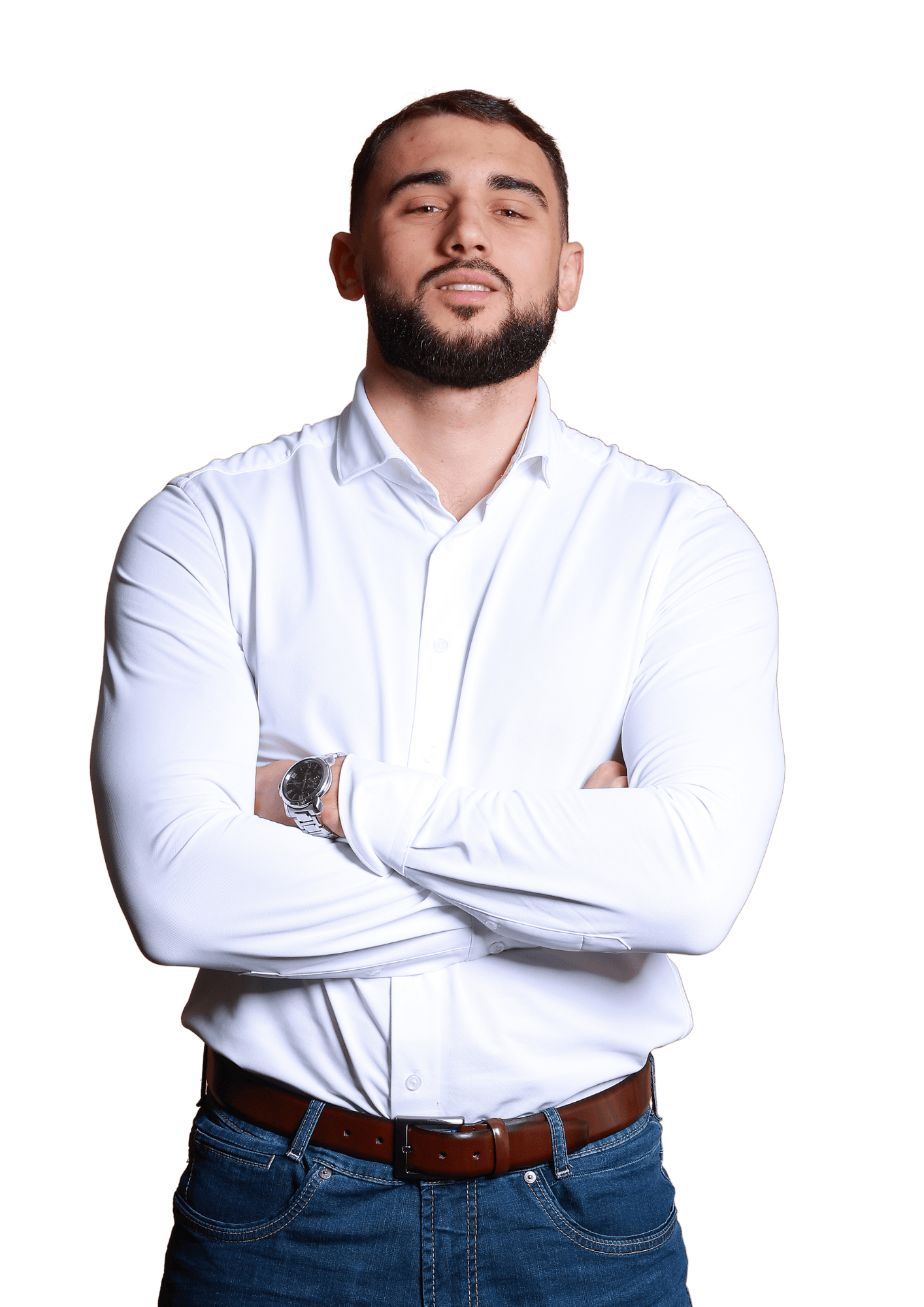 De afbeelding toont een zelfverzekerde man die met zijn armen over elkaar staat. De man is Josep Kool, eigenaar van High End Outdoor. Hij heeft kort donker haar en een baard. Hij draagt een wit overhemd met knopen, een bruine riem en blauwe jeans, en een zilveren horloge om zijn linkerpols.